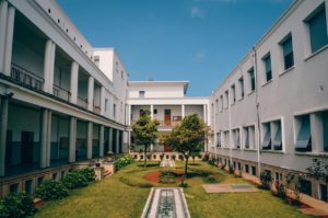Elegant university building with garden courtyard in Rabat, Morocco under clear blue sky.